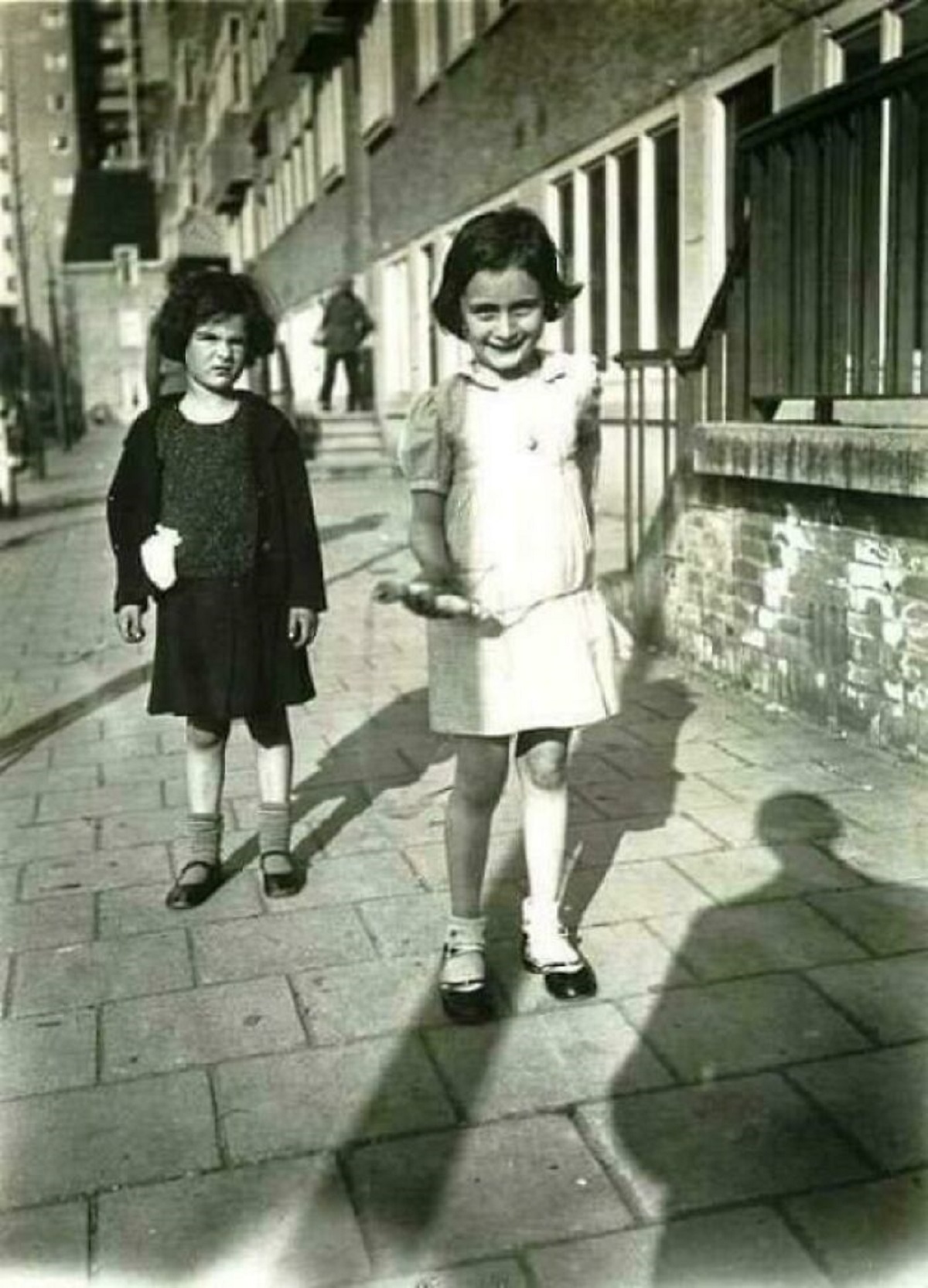 Six-Year-Old Anne Frank Holding A Jumping Rope Next To Her Friend, Sanne Ledermann, On A Pavement In Amsterdam. 1935