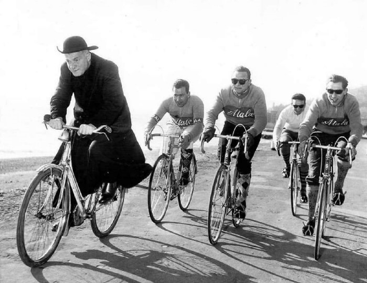 The Local Priest Takes A Strong Turn At The Front And Gives These Atala Cyclists A Break During Their Training Run In Preparation For The 1959 Giro D'italia Stage Race. Italy - Near Milan, 1959