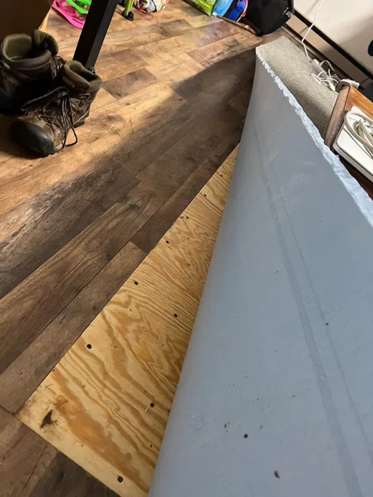 Rented an apartment and the landlord was bragging about getting new “wood” flooring installed. Well he missed a huge spot in the living room and just covered it with a cut out square of carpet. We’re talking about a large area of roughly 8×8 ft.