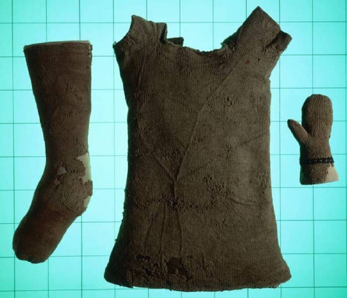 This sock, vest, and mitten were knitted for a baby in medieval Europe in the mid-16th century.