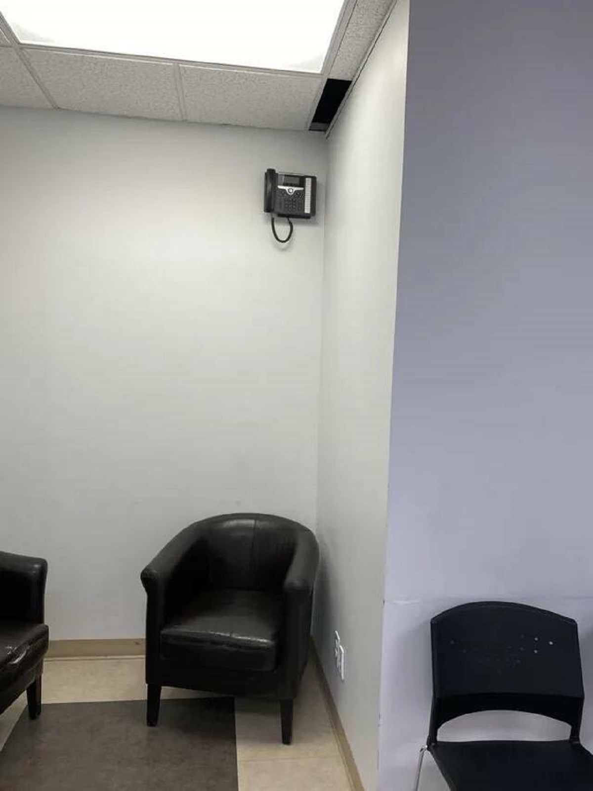 "Oddly placed phone in a waiting room"