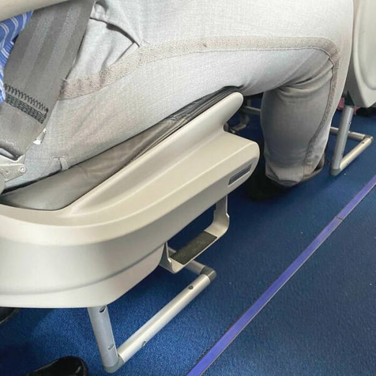 "This Airplane Seat Has A Step To Help Short People Reach The Overhead Locker"