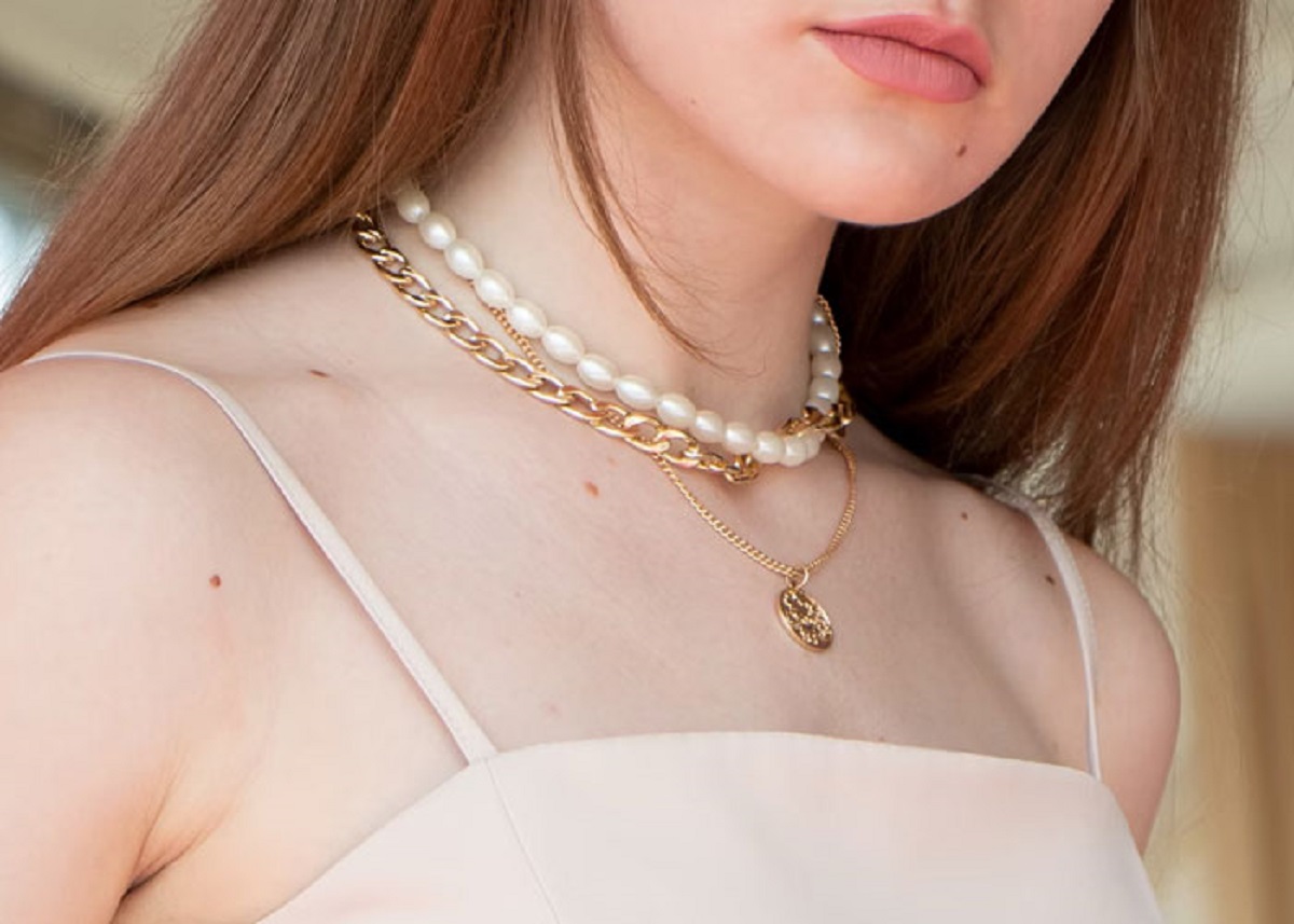 “Pearl clutching” references woman putting their hand to their chest (in supposed shock) while *wearing* the pearls. the pearls aren’t just in their pockets or something.