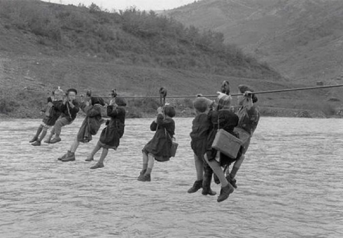 Children Cross A River Using Pulleys On Their Way To School In The Outskirts Of Modena, Italy, 1959, Technically Uphill Both Ways