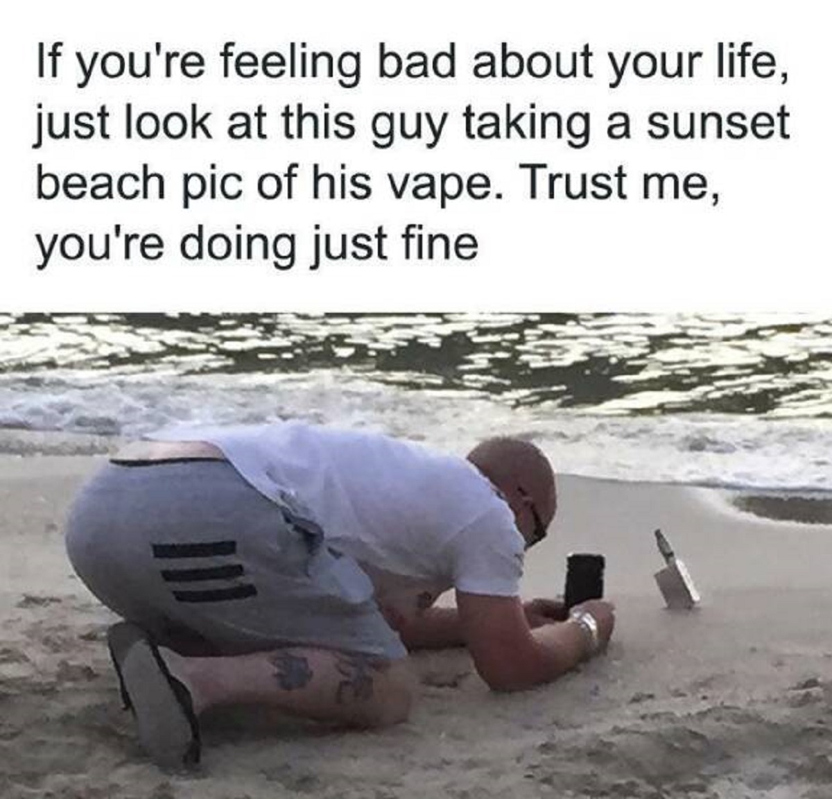 sand - If you're feeling bad about your life, just look at this guy taking a sunset beach pic of his vape. Trust me, you're doing just fine