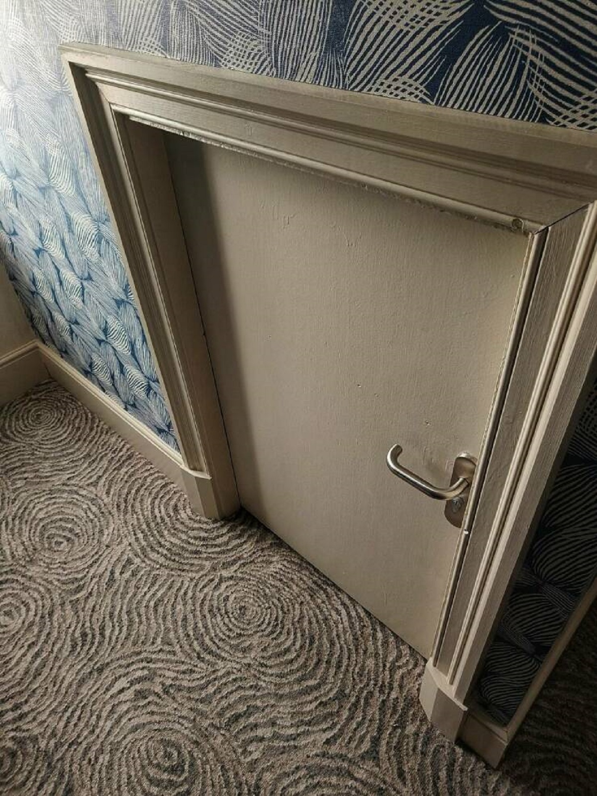 "Staying in a hotel room with a forbidden/locked mini-door that goes deep into the wall..."