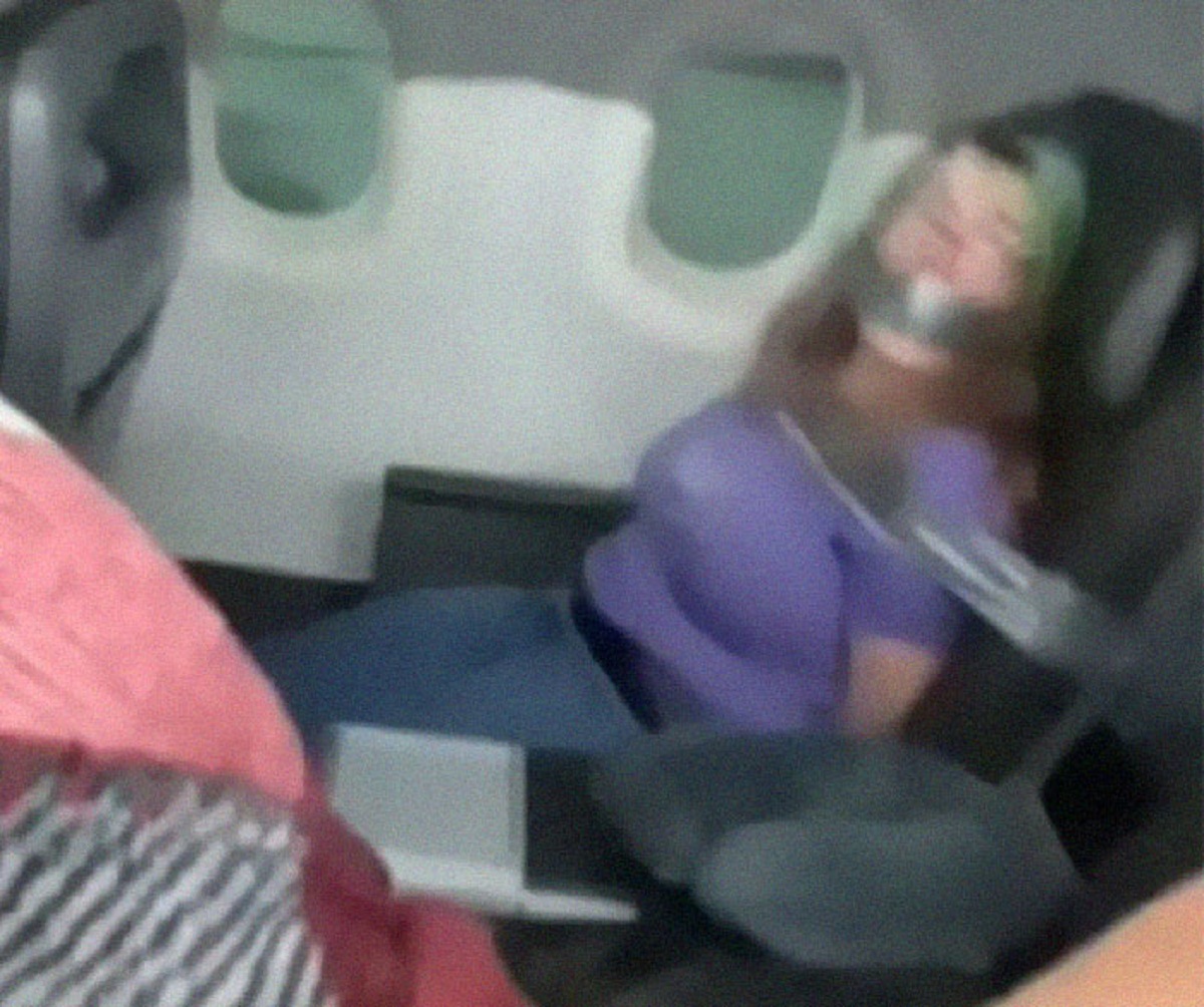 woman tries to open plane door