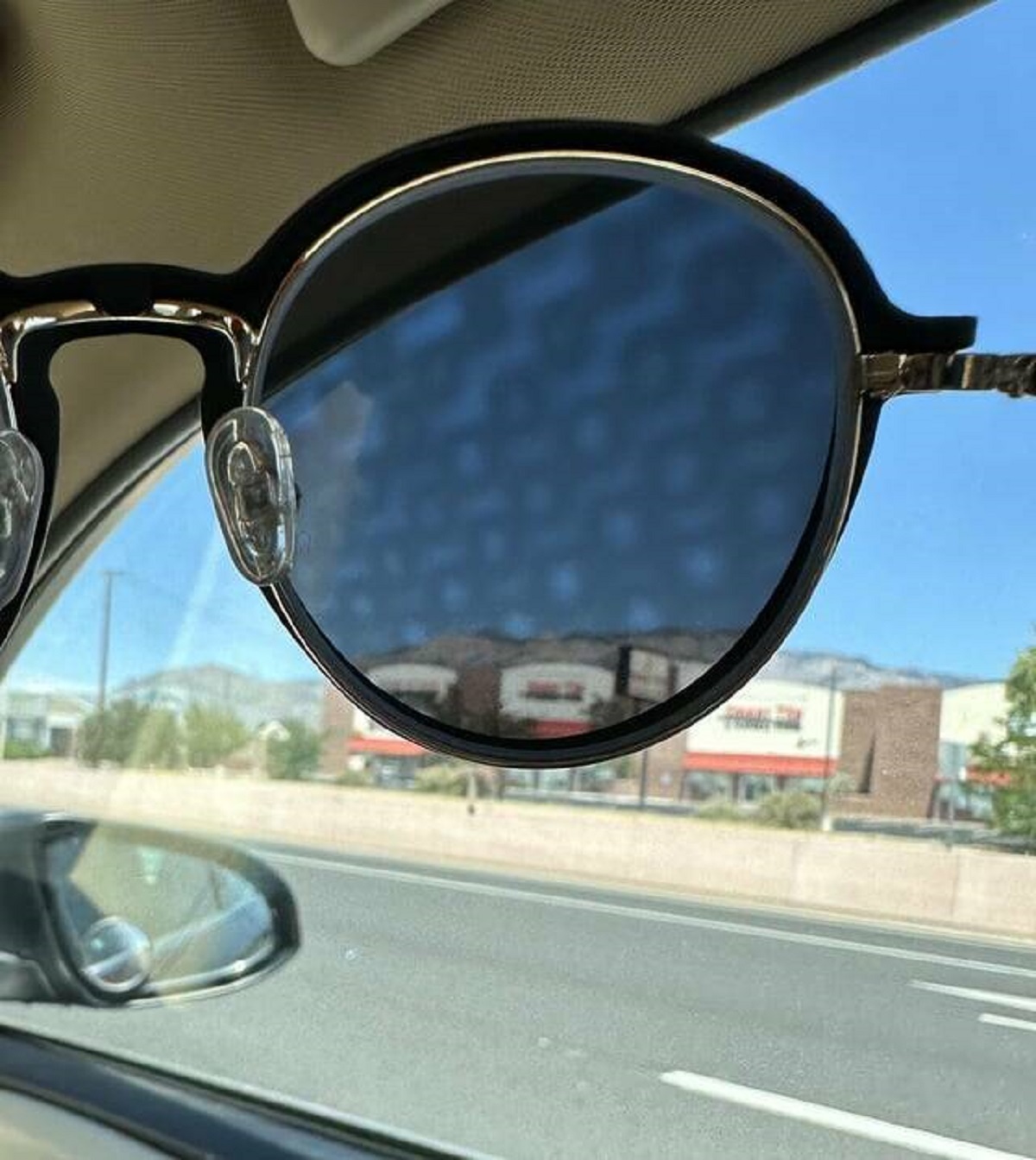 "My sun glasses allow me to see some otherwise invisible pattern on these car windows"