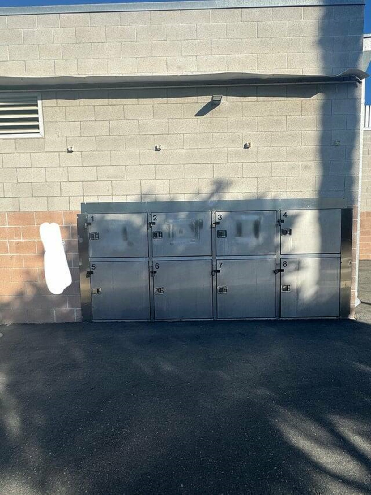 "The back alley of this animal shelter in San Diego has a night drop box for animals. The sign just the left has instructions for accessing a unit."