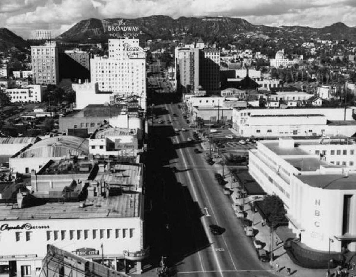 If you look at this photo of Hollywood (looking up Vine St.) from 1949, you can see that the sign still spells out "Hollywoodland" in the distance: