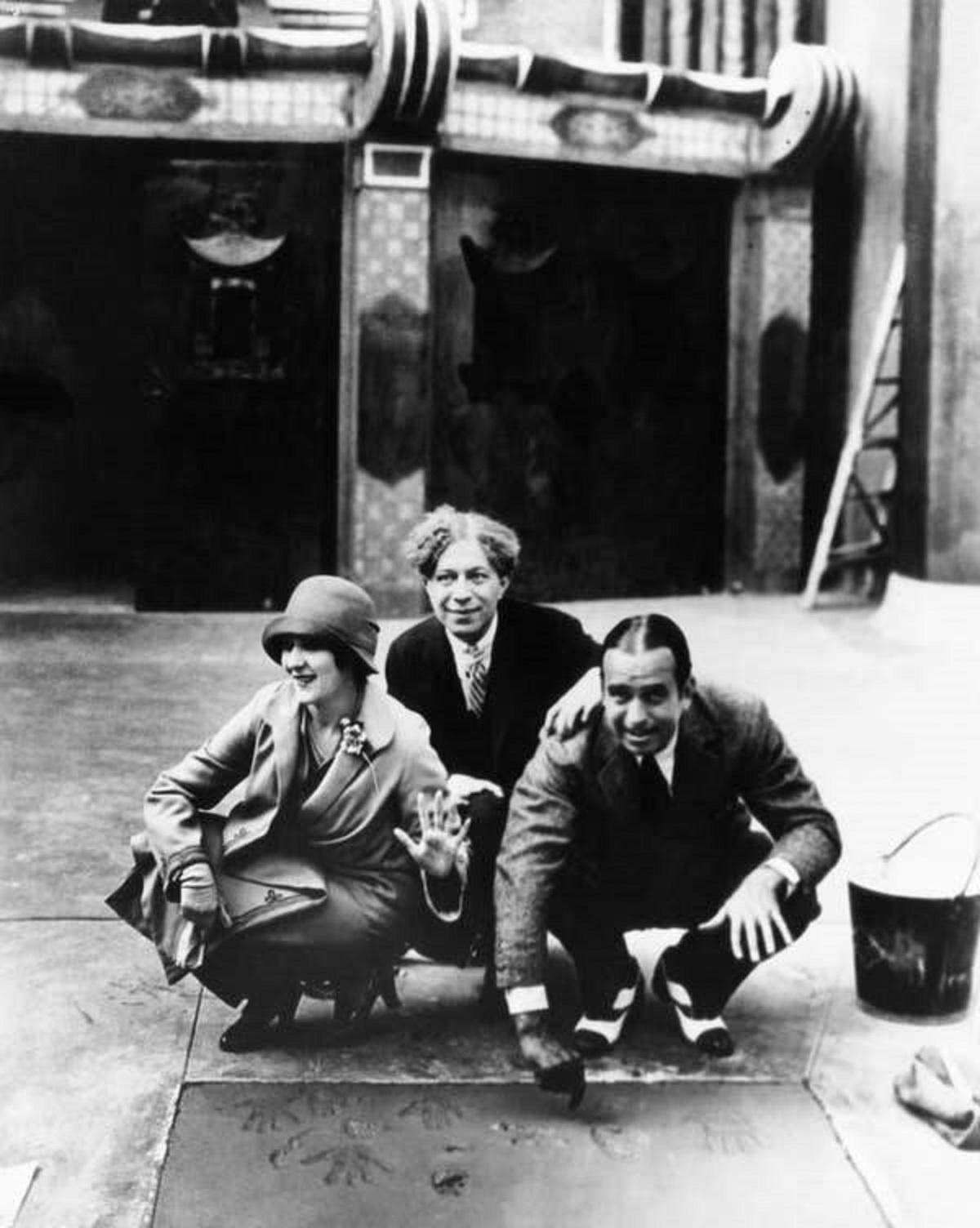 Here's a photo of Mary Pickford and Douglas Fairbanks putting their handprints and signatures in cement outside the Chinese Theater in 1927. They were the first two celebrities to ever do it: