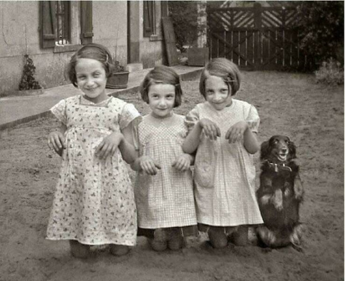 "Three Young Girls And A Dog Pose For The Camera. 1930"