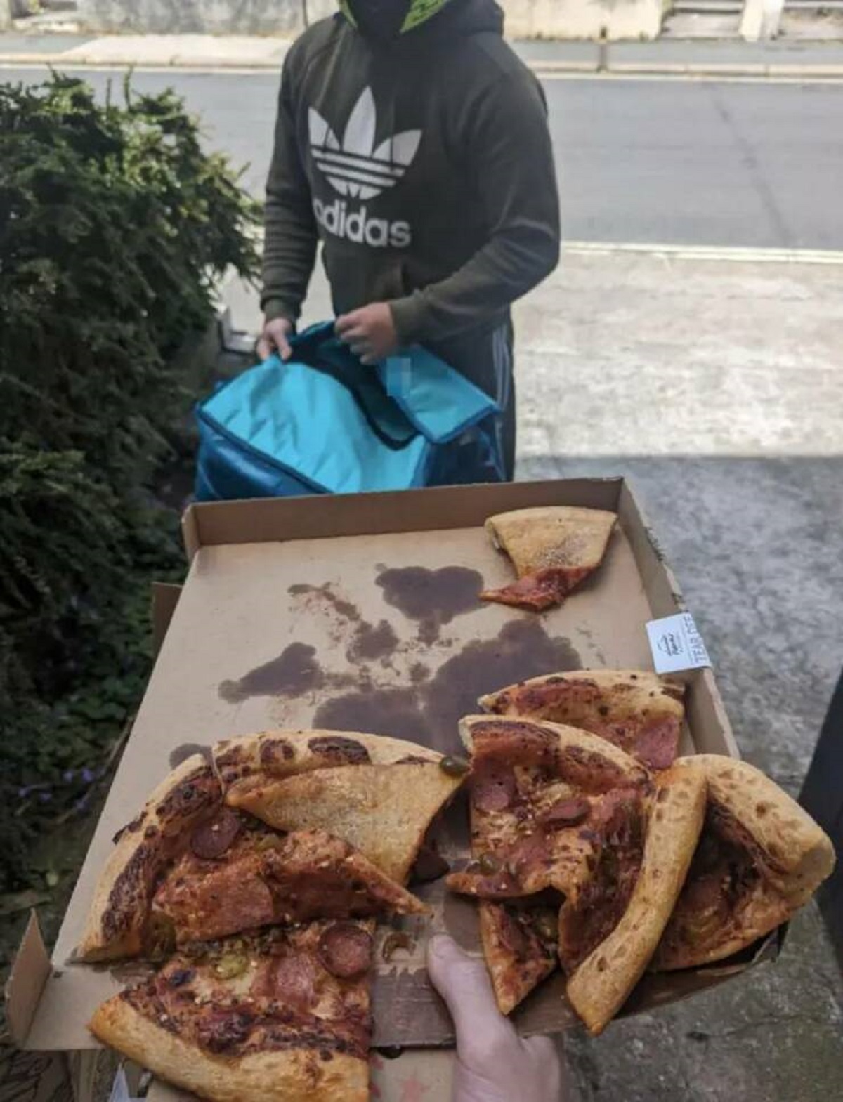 "This is how they handed my pizza to me, having scooped it bare-handed out of the bag":