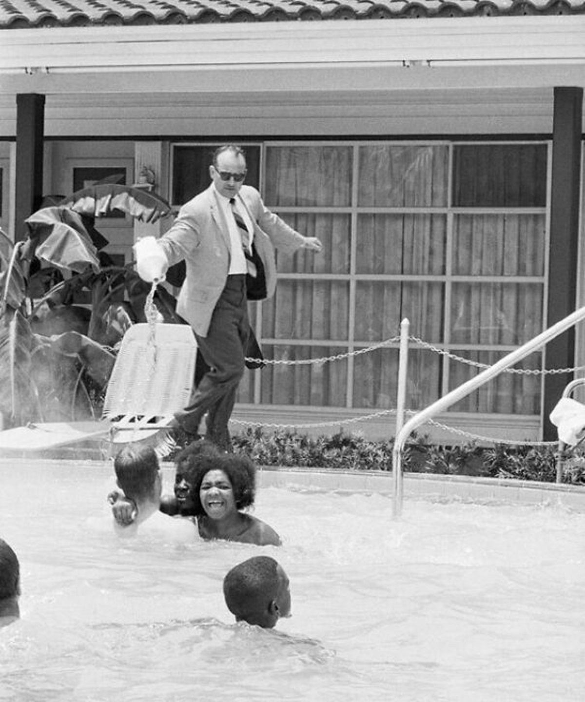 hotel manager pouring acid in pool