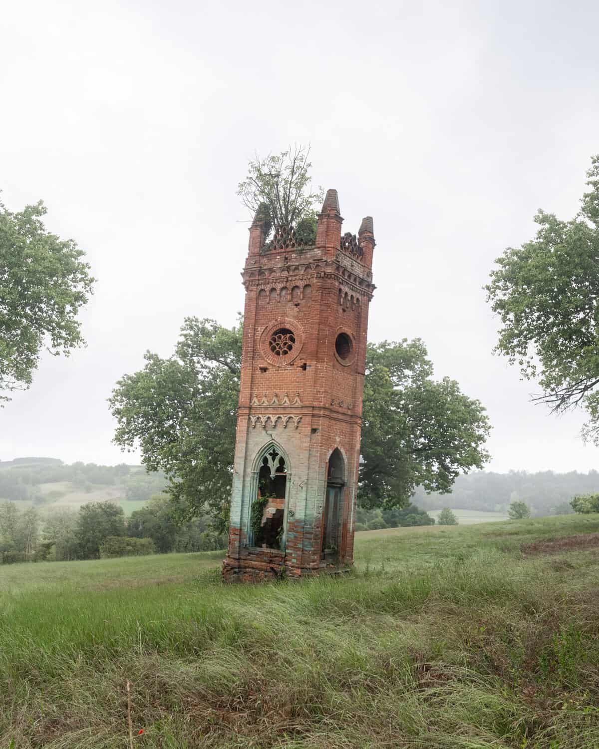 Desolate Gothic Tower Structure Amidst Serene Greens