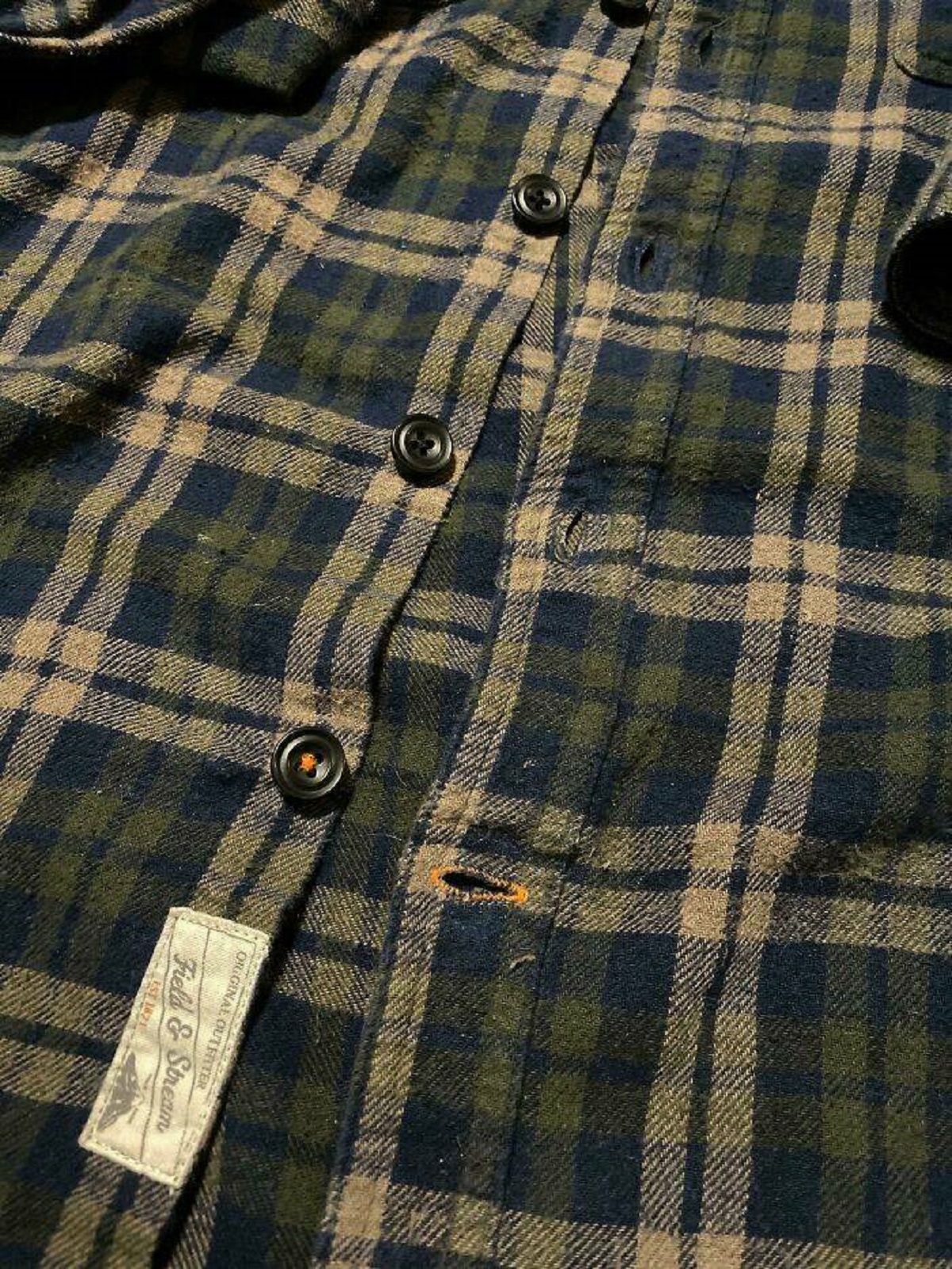 "This Flannel Button Up Has An Orange Thread On The Bottom Button Hole So That You Don’t Misalign The Buttons"