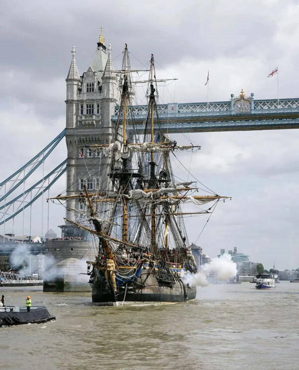 "A full-size replica of an 18th-century ship sailing down the River Thames in London during a tour of Europe."