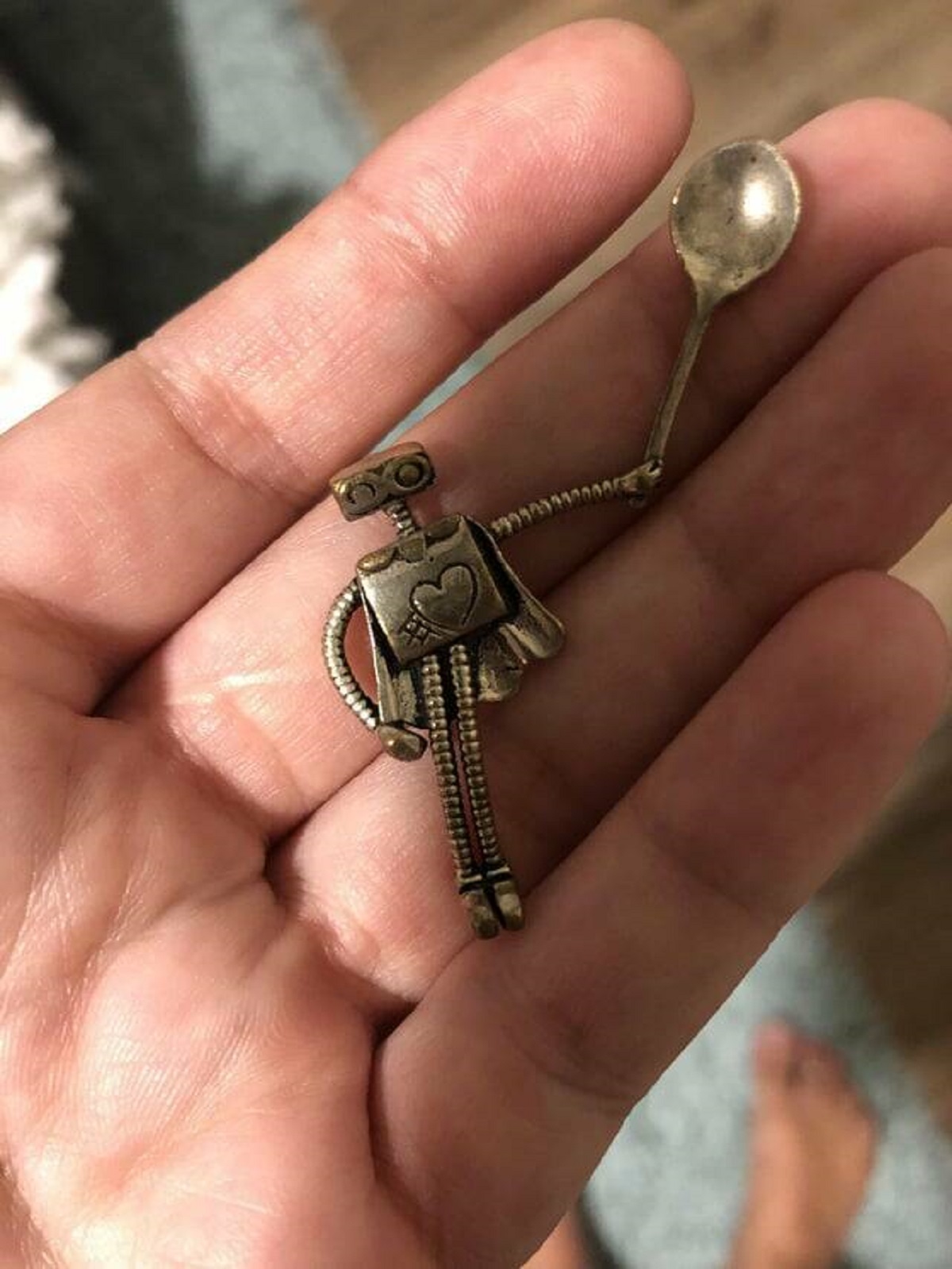 "Found this tiny metal robot holding a spoon at the beach today"