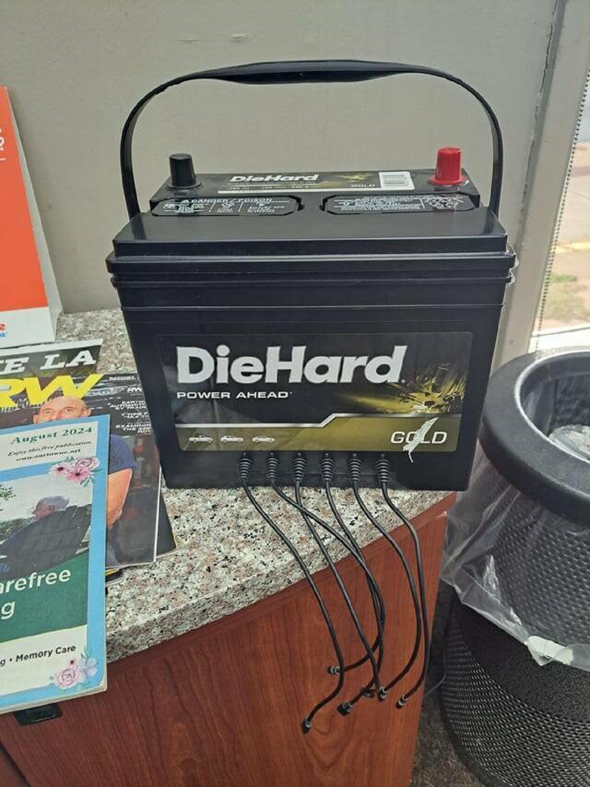 "This phone charger at the repair shop looks like a car battery"