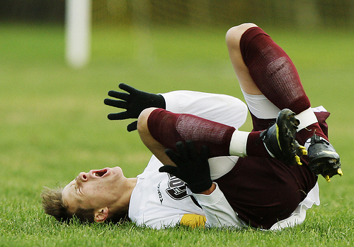 Soccer players falls down, gets boo boo.