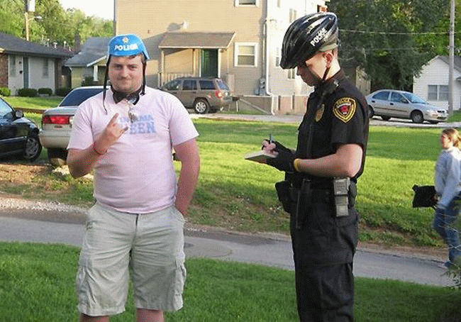 wear a pink tee shirt and a helmet with the word POLICE on it. 