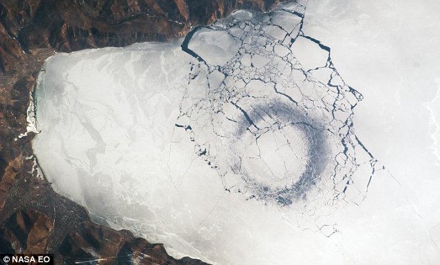 This strange almost perfect 'ice circle' has appeared on a frozen lake in Siberia. While scientists have ruled out UFO involvement, they are puzzled as to how the mysterious, 2.5mile-wide geological phenomenon has formed in Lake Baikal.