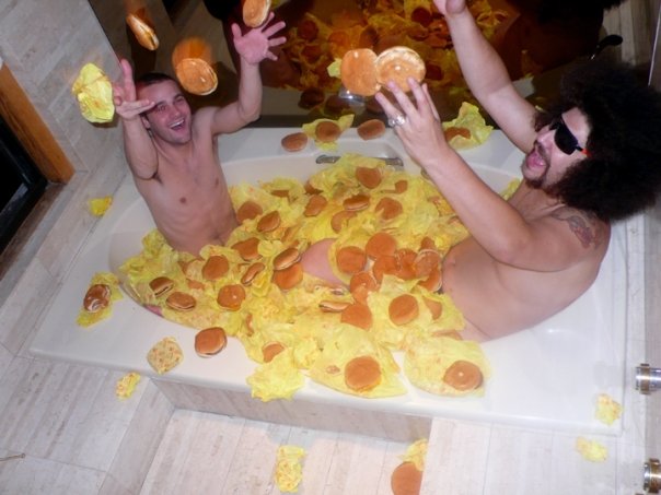 TWO MEN SIT IN A HOT TUB FULL OF CHEESEBURGERS. THIS IS EPIC.