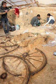 Archaeologists work around a 1,800-year-old bronze chariot at an ancient Thracian tomb near the village of Karanovo, east of the Bulgarian capital Sofia, Friday, Nov. 21, 2008.