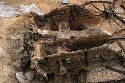 A part of a 1,800-year-old bronze chariot, seen, at an ancient Thracian tomb near the village of Karanovo, east of the Bulgarian capital Sofia, Friday, Nov. 21, 2008. Archaeologists have unearthed a well-preserved 1,800-year-old bronze chariot at an ancient Thracian tomb in southeastern Bulgaria, the head of the excavation said Friday. Along with the chariot, which was decorated with scenes from mythology, the team unearthed well-preserved wooden and leather objects, some of which the archaeologists believe were horse harnesses.