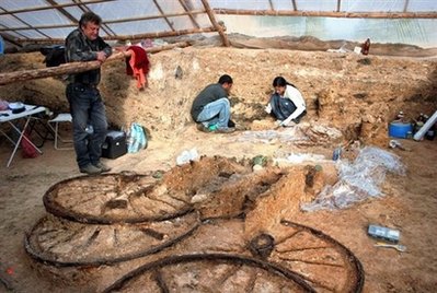 Bulgarian archaeologists work near a Thracian bronze chariot discovered near the village of Karanovo. A bronze chariot dating back to the second century AD has been unearthed in a Thracian burial mound in southeastern Bulgaria, archaeologists said Friday.
