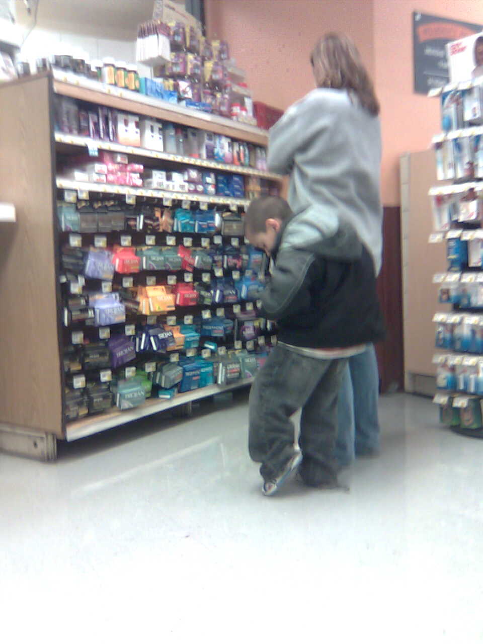 Mom takes her son condom shopping. I snapped a picture on my phone. Bad Parenting Award goes to this lady.
