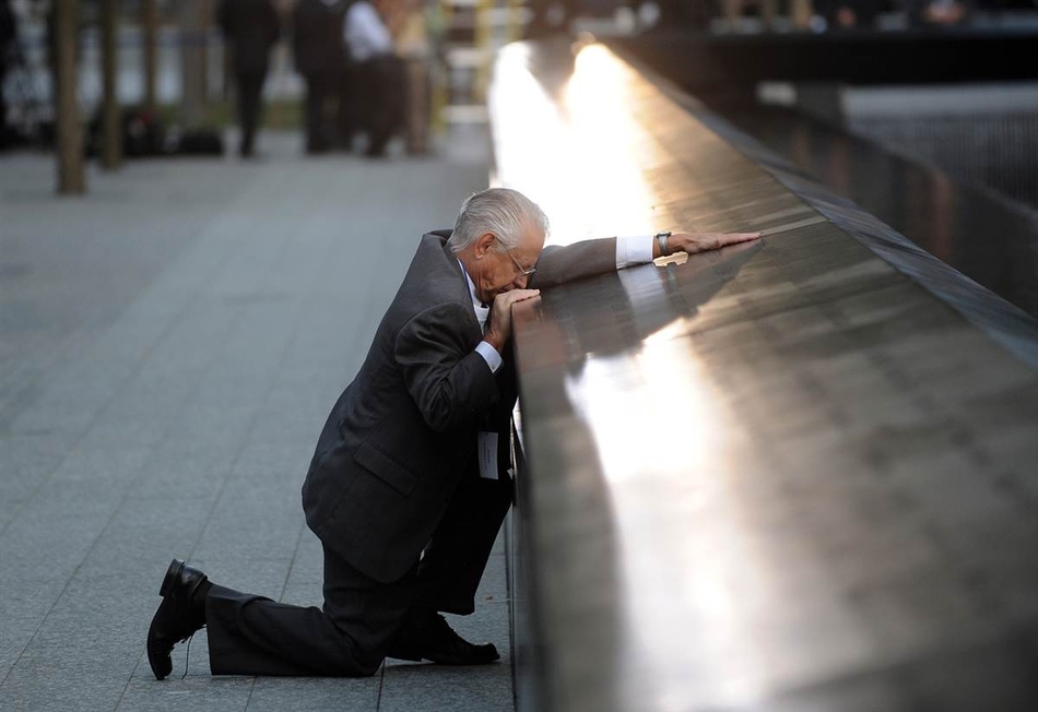 Robert Peraza, who lost his son Robert David Peraza in 9/11, pauses at his son’s name at the North Pool of the 9/11 Memorial.