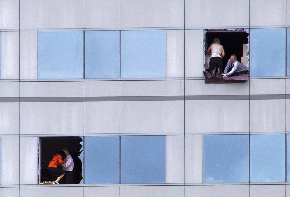 Office workers look for a way out of a high rise building in central Christchurch, New Zealand on February 22. A strong earthquake killed at least 180 people