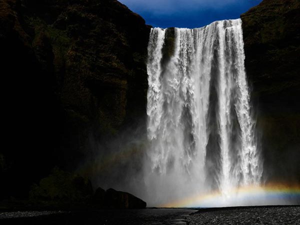 Beautiful rainbow with dangerous waterfall
