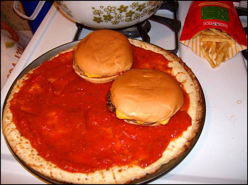 #2:Spread the tomato sauce equally on the crust,add the two cheeseburgers