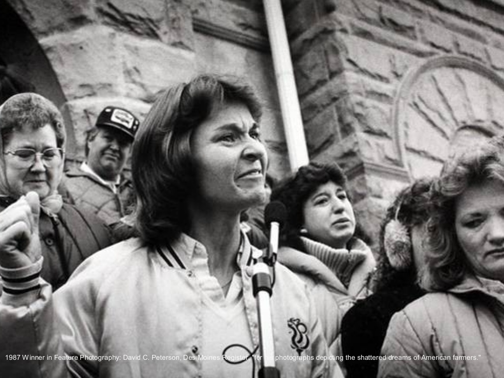Pulitzer prize winning photo  by David C. Peterson – “American Farmers.” taken in 1987 - Woman with clear hurt showing on her face standing by a microphone.