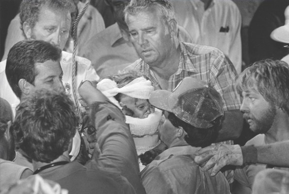 1988 Pulitzer prize winning photo by Scott Shaw of “Baby Jessica.”  - Taken October 14, 1987 – The man who pulled baby Jessica out of the well handing her over to firefighters.