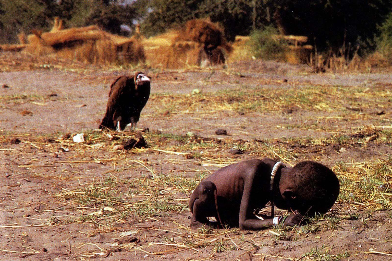 1994 Pulitzer prize winner Kevin Carter – “Vulture and Child." - A child who is too weak to make it to a feeding station has a vulture land nearby waiting for her to die.