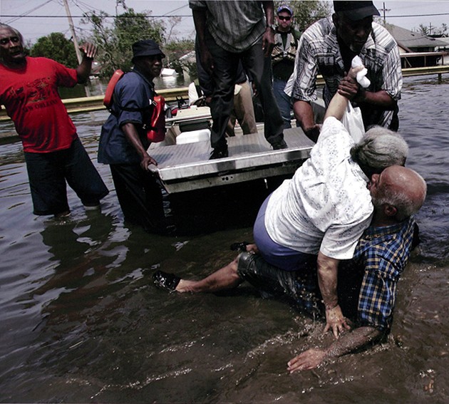 2006:  The Staff of the Dallas Morning News – “Hurricane Katrina.”  For its vivid photographs depicting the chaos and pain after Hurricane Katrina engulfed New Orleans.  In this picture:  New Orleans, LA -- Ibry Smith (right) fell as he helped Norma Rankins out of a boat after they were rescued from a nursing home in the Ninth Ward. (Irwin Thompson, August 30, 2005).