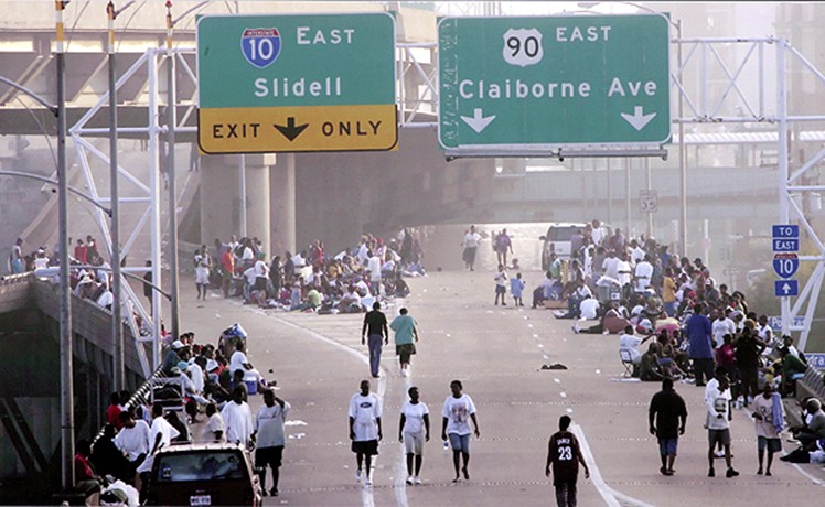 2006 Picture 2:  People wandered along Interstate 10 near the Superdome. Amid dire predictions, authorities decided to try to empty the city and move residents from the Superdome to shelters in Dallas and Houston in a two-day caravan of busses (Irwin Thompson, August 31, 2005).