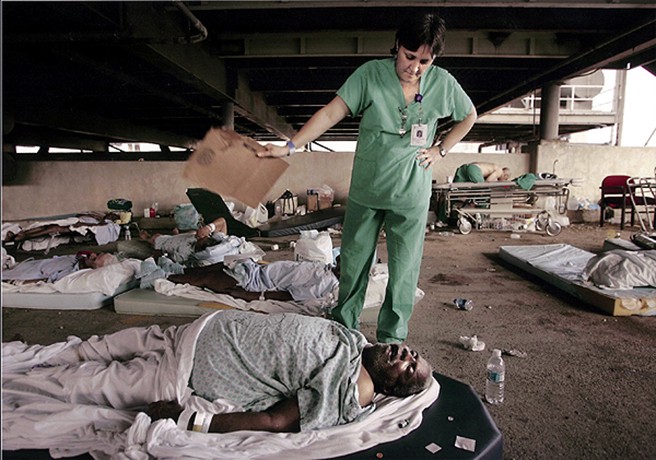 2006 Picture 3:  Memorial Medical Center nurse, Mary Jo D'Amico, fanned a patient waiting in the hospital's parking garage for helicopter transport from New Orleans (Brad Loper, September 1, 2005).
