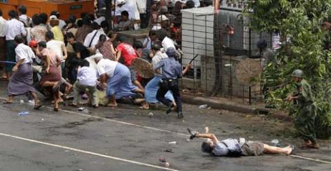 2008:  Adrees Latif – “Kenji Nagai.”  This is the winning photograph showing wounded Japanese photographer Kenji Nagai as he lay before a Burmese soldier in Yangon, Myanmar, as troops attacked protesters.  Nagai later died.
Nagai had been in Myanmar covering the anti-government protests since Tuesday, September 25. On Thursday, September 27, Nagai was photographing the protests near the Traders Hotel, a few blocks away from the Sule Pagoda in downtown Yangon, when soldiers opened fire on demonstrators, killing Nagai and reportedly injuring another foreign journalist.
Reports initially stated that Nagai was hit by stray bullets fired by soldiers or possibly shot from the front.  The "stray bullet" explanation was proposed by the government of Myanmar as an explanation for Nagai's death. However, video footage obtained by Japanese television appears to show a Burmese soldier shoving Nagai to the ground and shooting him at point-blank range.  A still image photographed by Adrees Latif showed the soldier standing over Nagai, who was sprawled on the ground and still clutching his camera. This photograph appeared on the front page of The New York Times on September 28, 2007. A subsequent shot showed Nagai's body sprawled in the street as the soldier walked away.  At the Japanese embassy in Myanmar, a physician established the trajectory of the fatal bullet that killed Nagai, determining that the bullet entered Nagai's chest from the lower right side and pierced his heart before exiting from his back.  In the next picture you can see the apparent bullet wound on the bottom right side of Nagai’s chest.
On October 8, new footage showing how a Burmese soldier apparently confiscating a fallen Nagai's video camera was revealed on a Japanese news show.  Adrees Latif's photo, depicting Nagai sprawling on the pavement before his death, won the Pulitzer Prize for Breaking News.