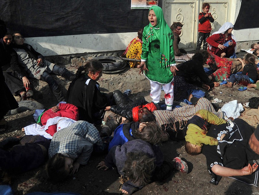 2012:  Massoud Hossaini – “The Girl in the Green Dress.”   Tarana Akbari, 12, screams in fear moments after a suicide bomber detonated a bomb in a crowd at the Abul Fazel Shrine in Kabul on December 06, 2011. 'When I could stand up, I saw that everybody was around me on the ground, really bloody. I was really, really scared,' said the Tarana, whose name means 'melody' in English. Out of 17 women and children from her family who went to a riverside shrine in Kabul that day to mark the Shiite holy day of Ashura, seven died including her seven-year-old brother Shoaib. More than 70 people lost their lives in all, and at least nine other members of Tarana's family were wounded. The blasts has prompted fears that Afghanistan could see the sort of sectarian violence that has pitched Shiite against Sunni Muslims in Iraq and Pakistan. The attack was the deadliest strike on the capital in three years. President Hamid Karzai said this was the first time insurgents had struck on such an important religious day. The Taliban condemned the attack, which some official viewed as sectarian.