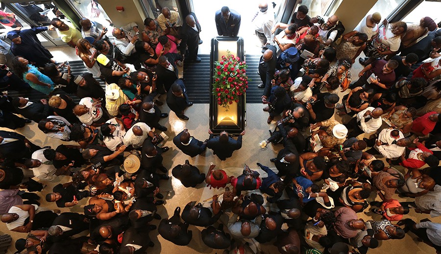 2015:  Photography Staff of St. Louis Post-Dispatch – “Despair and Anger in Ferguson, MO.”  For powerful images of the civil unrest in Ferguson, MO, stunning photojournalism that served the community while informing the country after the fatal shooting of Michael Brown by white police officer Darren Wilson on August 9, 2014
In this picture: The casket of Michael Brown exits Friendly Temple Missionary Baptist Church at the end of his St. Louis funeral. Thousands of mourners filled the church and lined the streets for Brown's farewell.