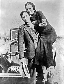 Bonnie & Clyde (Active from 1932-1934):  The legendary couple were the public face of the Barrow Gang, who, led by Clyde Barrow, terrorized Texas and the central United States for two years. Clyde Barrow was from a dirt poor family and began getting into scrapes with the law at an early age. He had several arrests on his record in his teens, and by the age of 21 he was serving time in prison.
Bonnie Parker was much more of a normal Texas girl who enjoyed photography and writing poetry. She fell in love with Clyde Barrow after a failed teenage marriage brought her back to her hometown of Dallas.
After the gang’s now notorious escape from their Joplin, Missouri hideout, several rolls of film yielded pictures of the young adults holding guns and smoking cigars. Although she became famous for these images, modern historians believe that Bonnie Parker probably hadn’t participated in any of the killings for which the gang became famous.