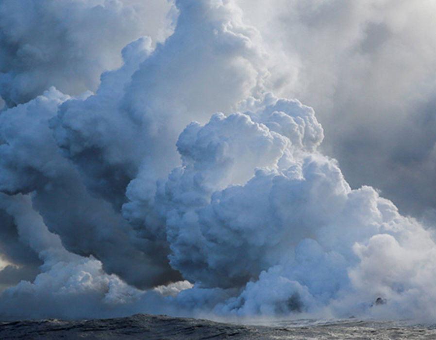 Steam rises as lava flows into the Pacific southeast of Pahoa.