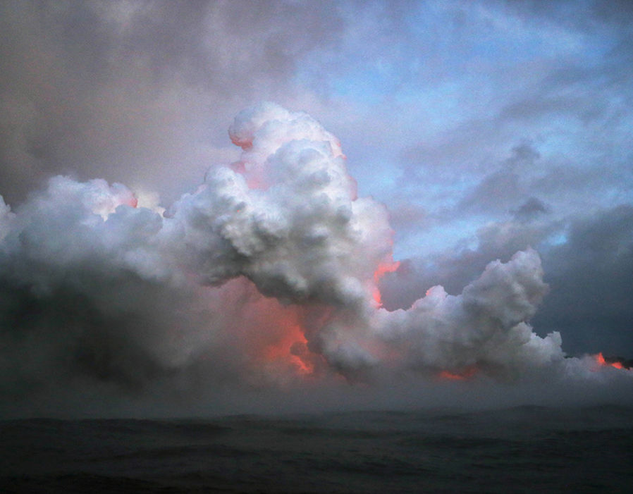 Lava glowing red as it enters the Pacific.