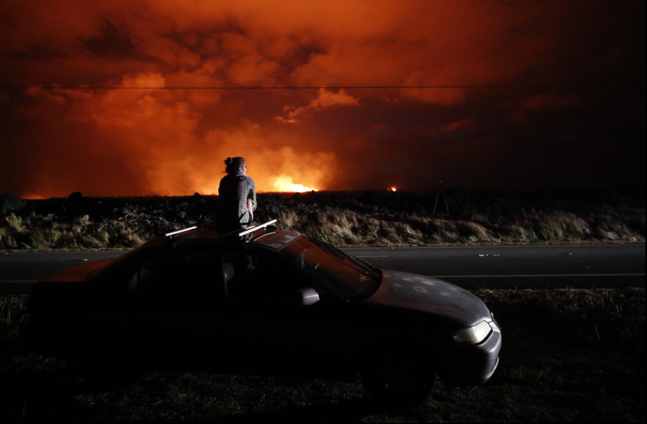 A local resident pauses to watch the eruption.