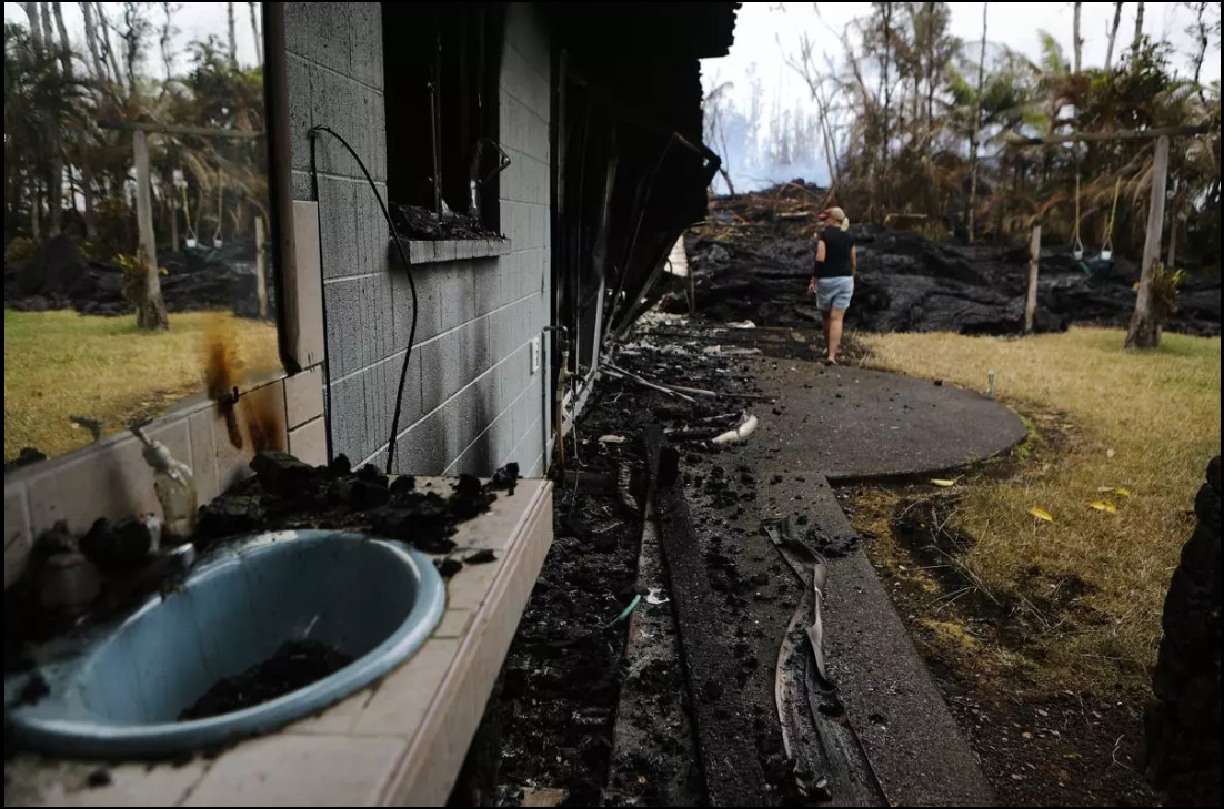 A local resident inspects the damage of a destroyed home.
