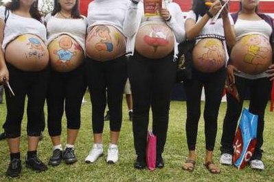 Pregnant women with their bellies painted take part in an event to celebrate "Healthy Maternity Week
